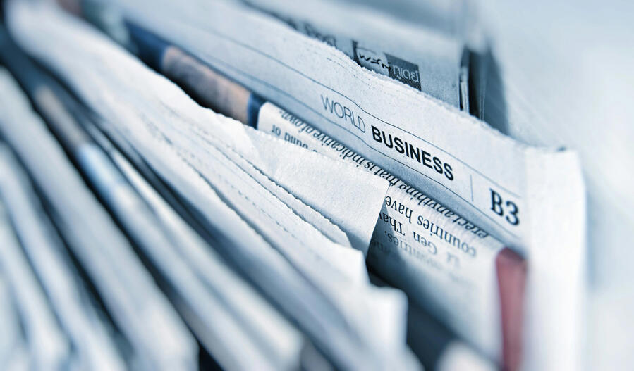 Close up of newspapers stacked horizontally